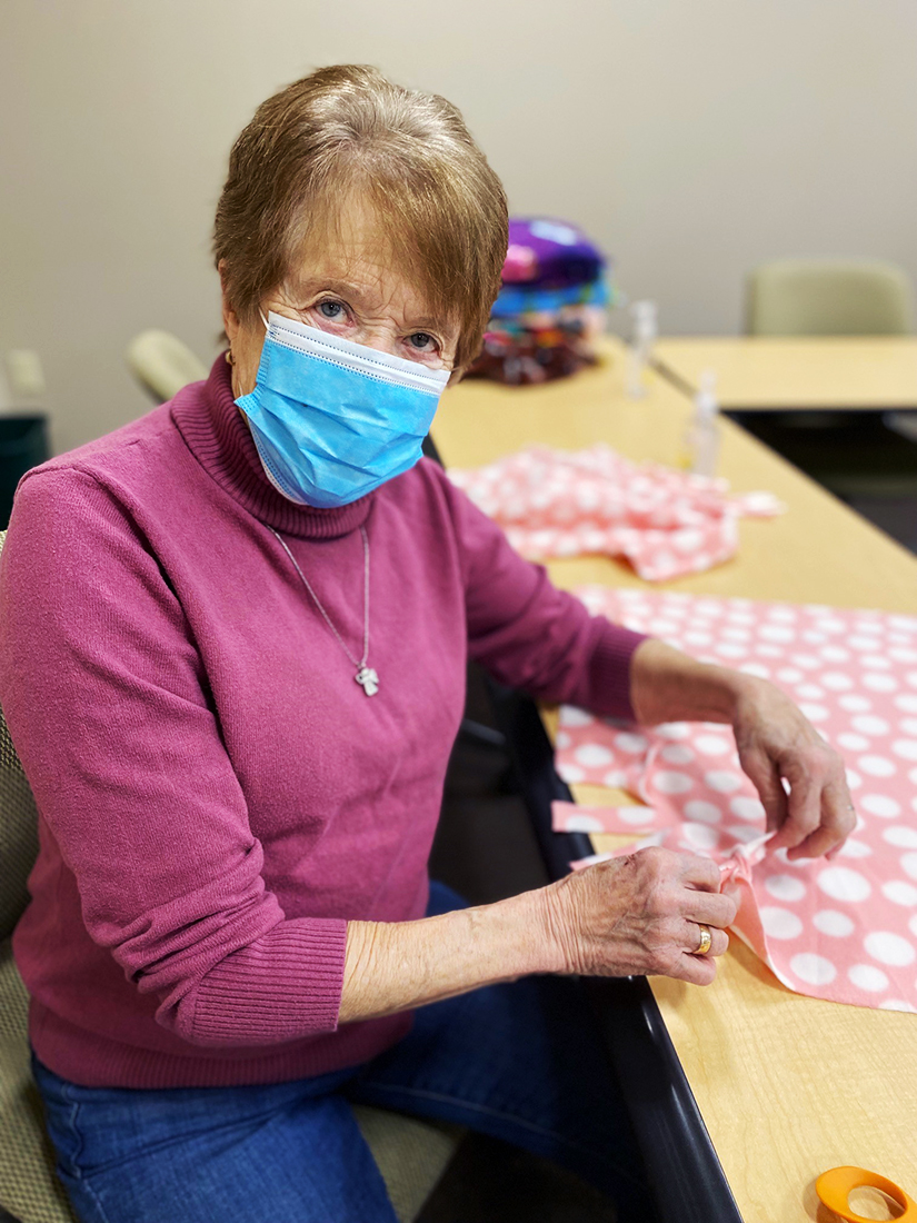 Volunteer making fleece blanket