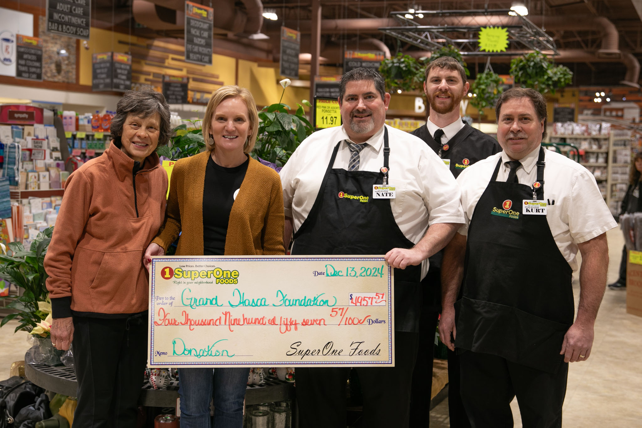 Super One Foods representatives presenting a giant check to support the Patient Crisis Fund